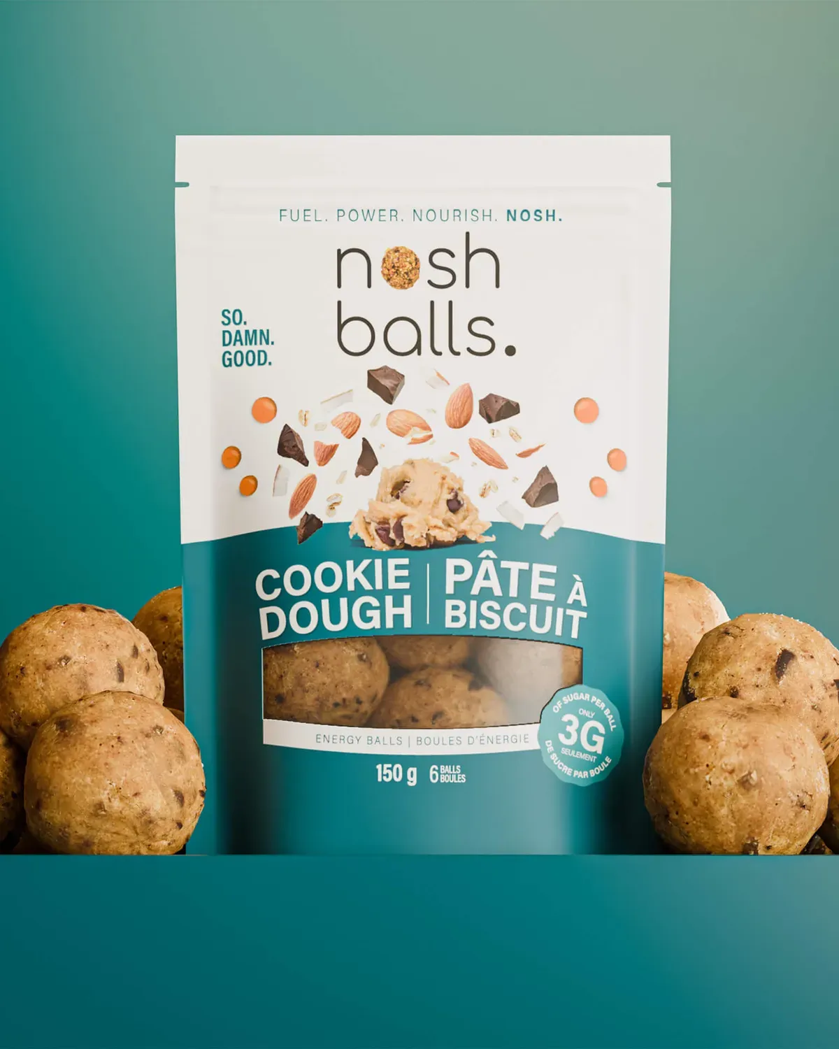 Nosh Balls cookie dough pouch with energy bites on a teal set